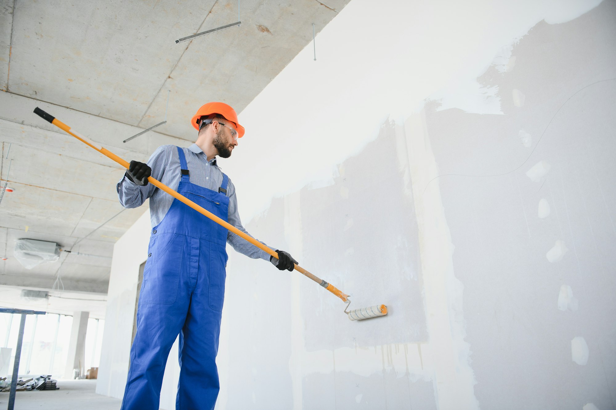 painter man painting the wall, with paint roller