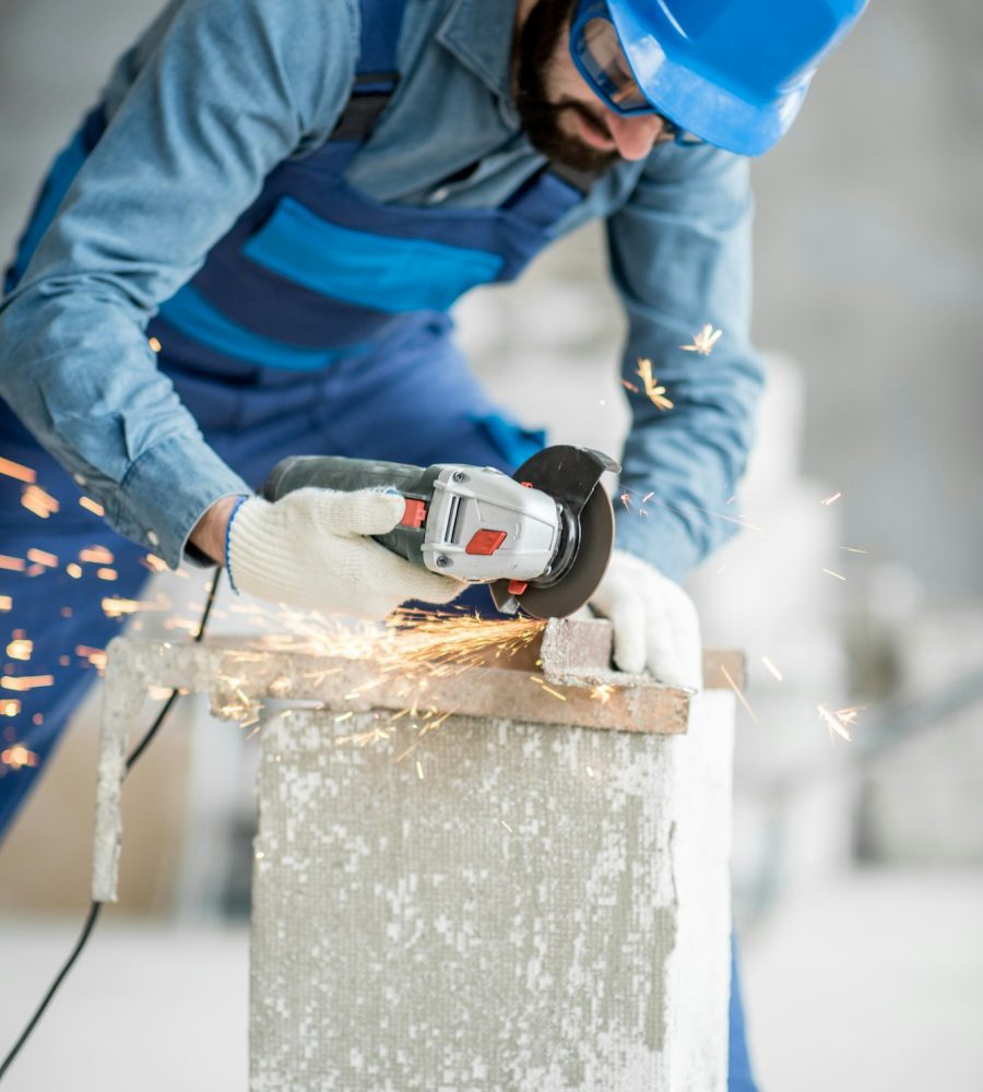 Builder cutting metal indoors